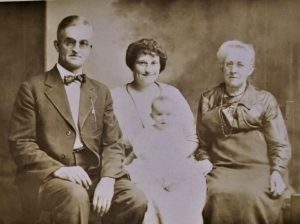 16My Deeply Rooted "American" Family - 4 Generations of the CARRIER-REYNOLDS FAMILY in Central New York StateDebbie JohnsonOnondaga CountyGrandma always said, "We are Americans", whenever I asked about our nationality. I knew we weren't Native American Indians, yet I couldn't get Grandma to change her story. I'd peer into this 4-generation photo of my CARRIER & REYNOLDS family, hoping to find a clue as to the origins of the CARRIER surname...thinking it's derivation might be French.
The eldest pictured in this August 1922 post card photograph are: ADORA (Reynolds) CARRIER (far right) at 73 years of age, her son FRANK CARRIER (far left) at 50 years of age & his daughter BERTHA (Carrier) LAVANCHER-my Grandmother (in the center) at 26 years of age- holding her baby HELEN (my mother) who was just 5 months old. In addition, I often wondered if the CARRIER surname had any connection to the CARRIER AIR-CONDITIONING CO., where my father worked. When queried, both Grandma and my Dad always said, "No connection." 
With Grandma's decease, research became my ally. It took decades before I pieced the puzzle together to resolve these looming questions. Neither Grandma nor my father realized the connection to CARRIER AIR-CONDITIONING CO. whose founder, Willis Carrier, was a distant cousin of our family. BUT, I have to share that Grandma was 100% correct about being American! My CARRIER line traces all the way back to 1600's Massachusetts...and beyond that, into England.