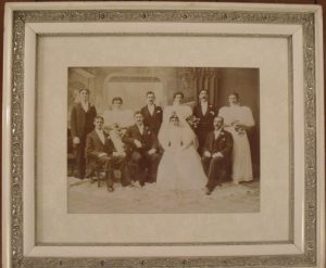 17Grandma & Grandpa Schloeder's Wedding Portrait - 1896Emily & Mary HerbstOnondaga CountyJohn Schloeder and Lizzie Waibel, our mom's parents, were married on June 2, 1896 at Assumption Church on North Salina St. Their parents had emigrated from Germany, but both the bride and groom were born in Syracuse. The portrait of their wedding party was taken by Frey Art Gallery on North Salina St. The photographer was also a member of the wedding party. The wedding celebration lasted for 3 days. In addition to owning this wedding party portrait in its original frame and the marriage certificate (in German), we also have all of the receipts from the celebration - photographer, florist, bakery, brewery, food purveyors, etc. A veritable history of the North Side just before the turn of the century.