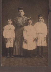 13Harley Banks with mother & sistersSusan HamiltonOnondaga CountyThis cozy domestic scene belies a sad mystery not yet unraveled. The photo must've been taken around 1900, when my grandfather Harley Banks was 4, because sometime that year his mother died, leaving behind 4 children & a husband. The family had already split up when the census was taken in April, with little Harley living as a boarder in the home of non-relatives. His father was also a boarder elsewhere, and the 3 sisters scattered among relatives or lived as an "adopted" daughter/servant with yet another family. The mother, Mary Lyon Banks, lived with a brother. Harley had left school by the age of 14, when he was censused as a hired hand on a pig farm in southern Minnesota. He later moved to St. Paul, married my grandmother, and had 2 sons. But Harley became an alcoholic, and after serving in two world wars, once again went off on his own. He died in Chicago, in a skid-row neighborhood. I never had a chance to meet him.