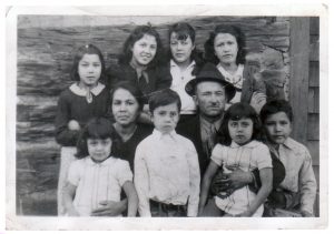5Mary Winder's FamilyKandice WatsonOnondaga CountyThis photo is of my great-grandmother, Mary Winder, my great-grandfather Samuel and their children. My grandmother is Mamie, standing second from the left. My family is quite large and I have taken on the role of family historian for my cousins, aunts and uncles. As the Documentarian for the Oneida Indian Nation, I am always doing genealogy and trying to find articles regarding our Nation’s history that will help our members connect with past generations. Unfortunately, it is difficult to find primary resources for Indian people prior to around 1800, but I certainly do my best and Ancestry has enabled me to find records I never knew existed. I am only half Indian and my non-Indian Aunt on my father’s side has researched my family and found that some arrived on the Mayflower! I also have an uncle that married President James Monroe's daughter. In addition, I learned that my ancestor, John Watson, was the Bishop of Winchester in the 1580's. Apparently, he had bribed an official to ensure that the Queen did not make him Bishop. She found this action more pleasing than if he had bribed someone to MAKE him the Bishop and she bestowed the position upon him against his wishes.