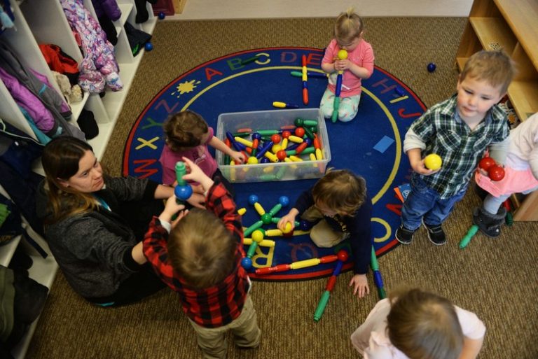Crystal Emmons, a program technician at the McRaven Child Development Center, plays with the children in her classroom at Ellsworth Air Force Base, S.D., Feb. 6, 2018. The CDC on base is one of only five childcare centers in South Dakota that is accredited with the National Association for the Education of Young Children, which is an organization that helps children grow and gives them a chance to be more successful in the future. (U.S. Air Force photo by Airman 1st Class Thomas Karol)