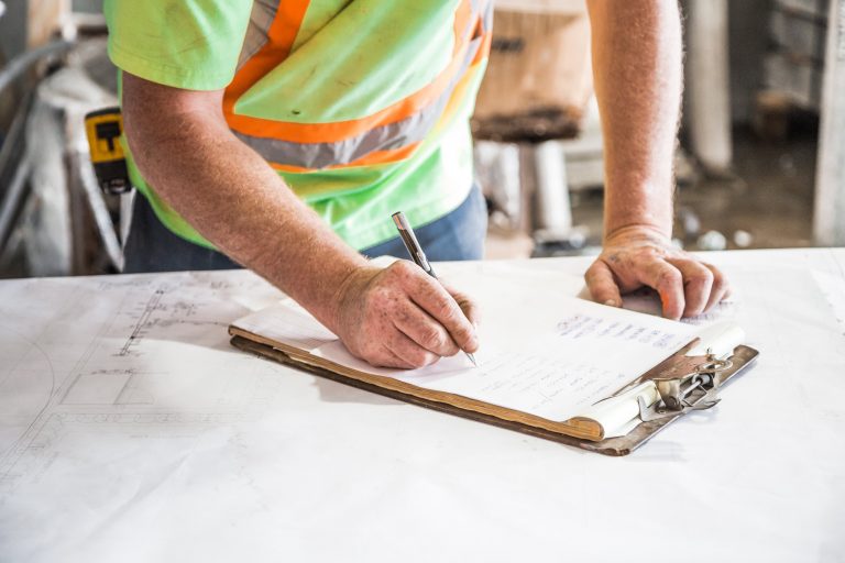 Construction writes on a clipboard