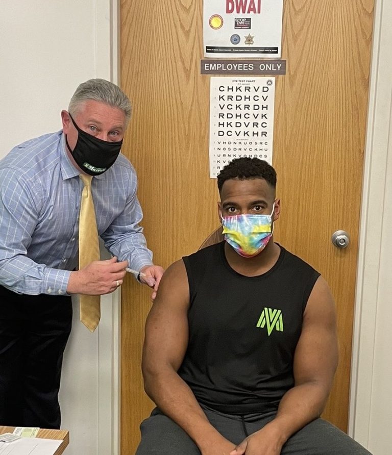 John McDonald gives a vaccine