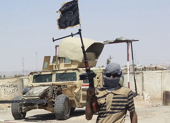 A fighter of the Islamic State of Iraq and the Levant (ISIL) stands guard at checkpoint near the city of Biji